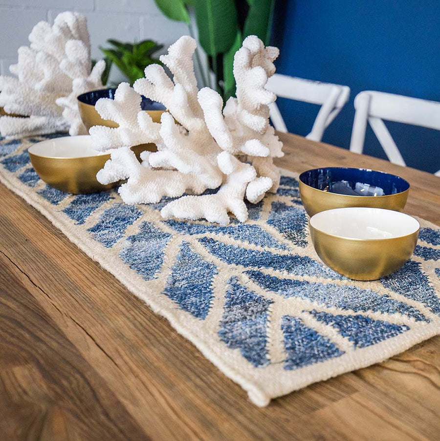 Coastal style upcycled denim blue and sustainable jute table runner in herringbone pattern.