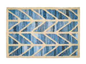 Coastal style upcycled denim blue and sustainable blonde jute door mat in herringbone pattern.